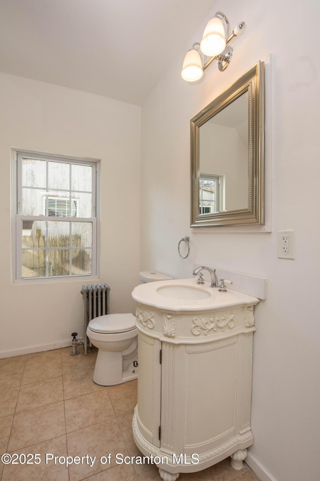 bathroom featuring baseboards, toilet, radiator heating unit, tile patterned floors, and vanity