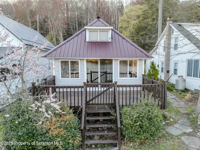 446 Lake Rd, Nicholson, PA 18446 - bungalow-style home featuring metal roof, a sunroom, a wooden deck, and stairway
