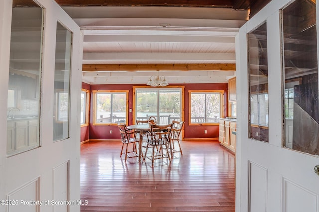 446 Lake Rd, Nicholson, PA 18446 - dining area featuring beam ceiling, wood finished floors, a notable chandelier, and baseboards