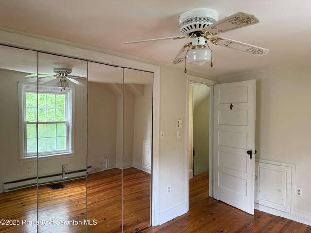 308 Marion St, Clarks Summit, PA 18411 - unfurnished bedroom featuring wood finished floors, a closet, ceiling fan, baseboards, and baseboard heating
