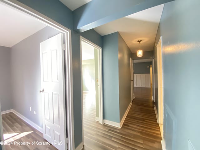 hallway with wood-type flooring