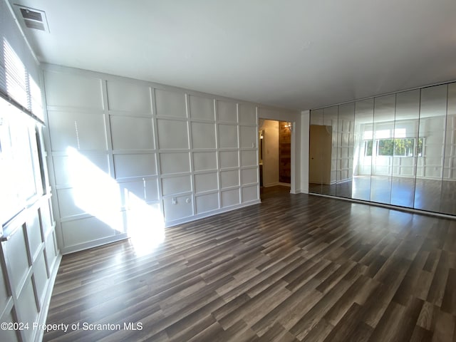 interior space with a healthy amount of sunlight and dark hardwood / wood-style flooring