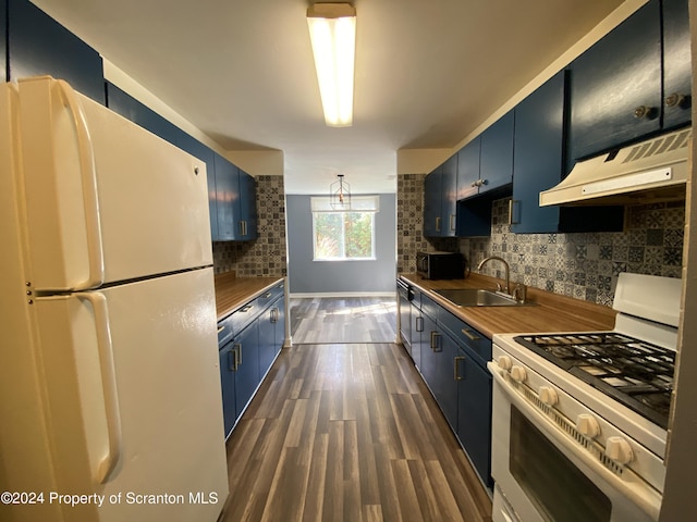 kitchen with blue cabinets, sink, wooden counters, and white appliances