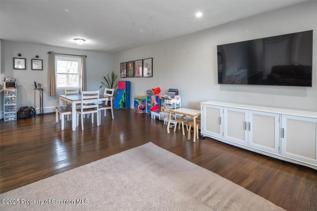 dining area featuring dark wood-style flooring