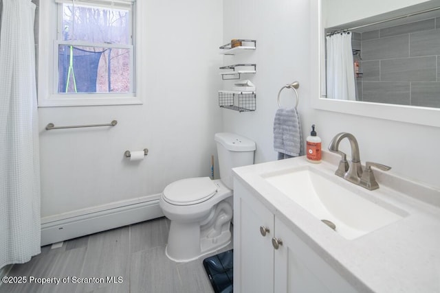 bathroom with toilet, a shower with curtain, baseboard heating, and vanity