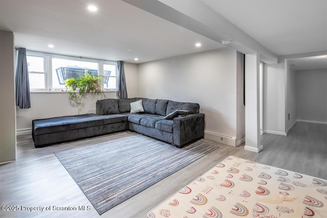 living area featuring baseboards, wood finished floors, and recessed lighting