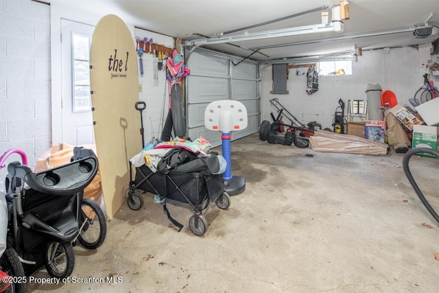 garage featuring concrete block wall and electric panel