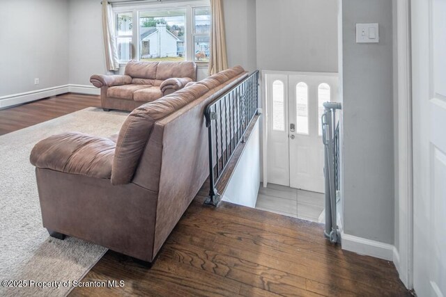 living room with baseboards and wood finished floors