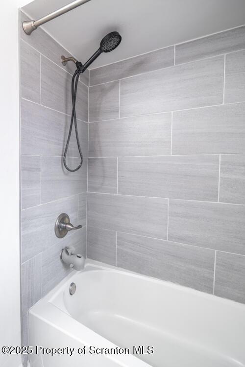 bathroom featuring  shower combination