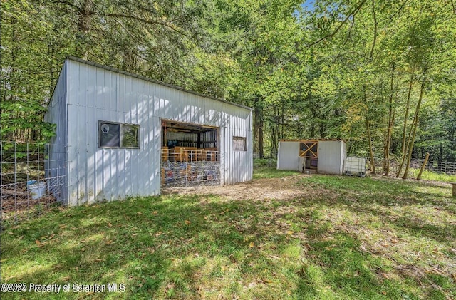 view of outbuilding with a yard