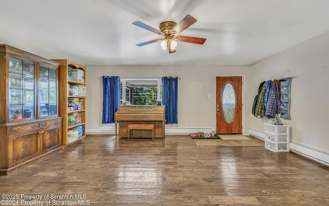 entryway featuring a baseboard heating unit, dark wood-type flooring, and ceiling fan