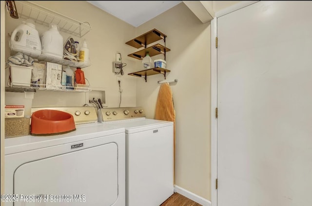 clothes washing area with washing machine and clothes dryer