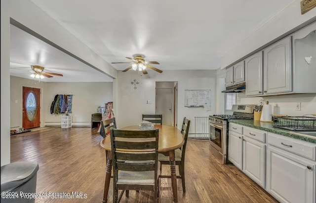 kitchen with stainless steel gas stove, wood-type flooring, and ceiling fan