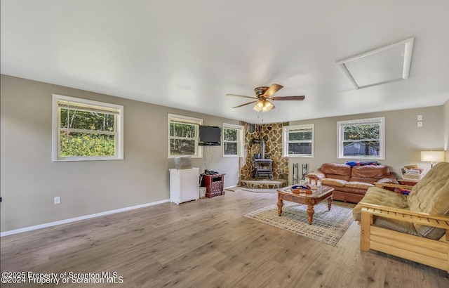 living room with a wood stove and hardwood / wood-style floors