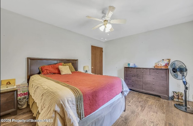 bedroom with ceiling fan and light hardwood / wood-style flooring