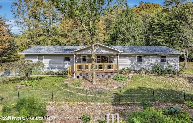 view of front of house with a wooden deck and a front yard