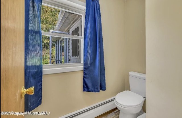 bathroom with a baseboard heating unit and toilet