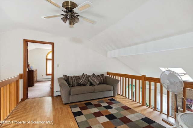 living room with vaulted ceiling, light wood-type flooring, baseboard heating, a baseboard heating unit, and ceiling fan