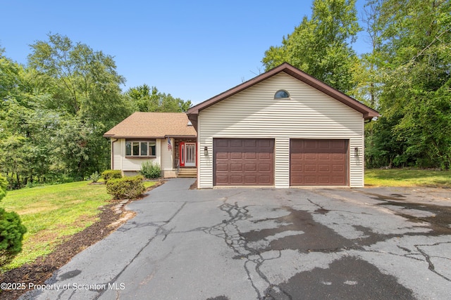 ranch-style house with a front lawn, driveway, and an attached garage