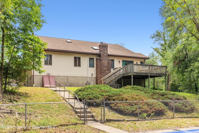 rear view of house featuring cooling unit, fence, a deck, and stairs