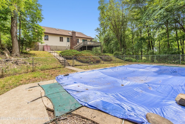 view of pool with a fenced backyard, a fenced in pool, stairway, and a deck