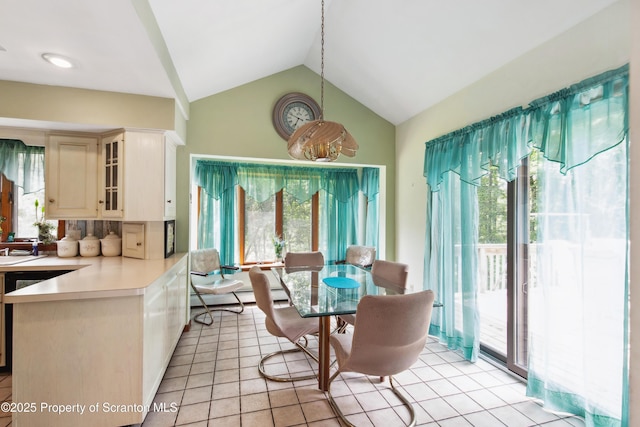 dining room featuring light tile patterned floors, lofted ceiling, and a wealth of natural light