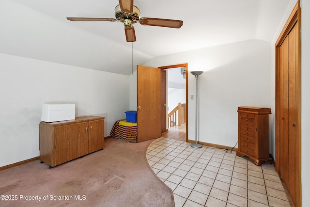 bonus room featuring baseboards, lofted ceiling, a ceiling fan, and light carpet