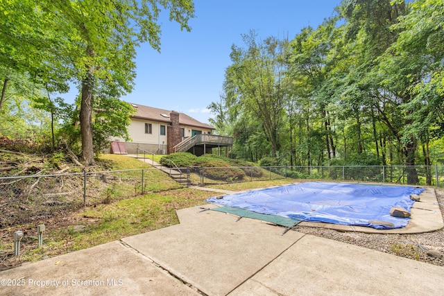 view of swimming pool featuring fence, a patio, stairs, a wooden deck, and a fenced in pool