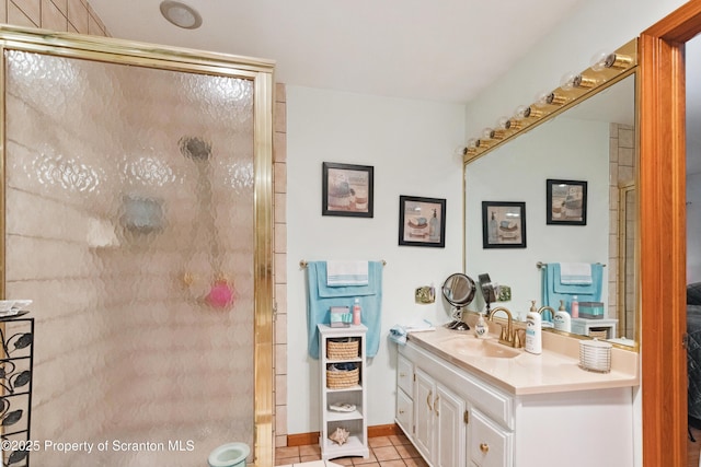 bathroom with a shower stall, tile patterned flooring, and vanity