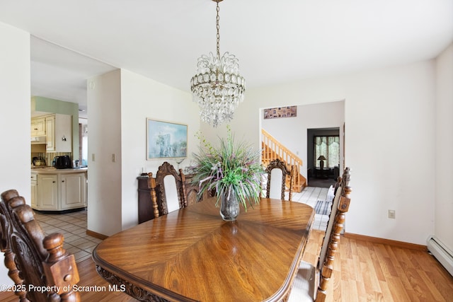 dining area with stairs, baseboards, a chandelier, light wood finished floors, and a baseboard radiator