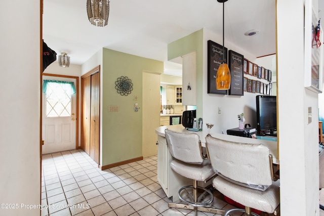 kitchen with baseboards and tile patterned flooring