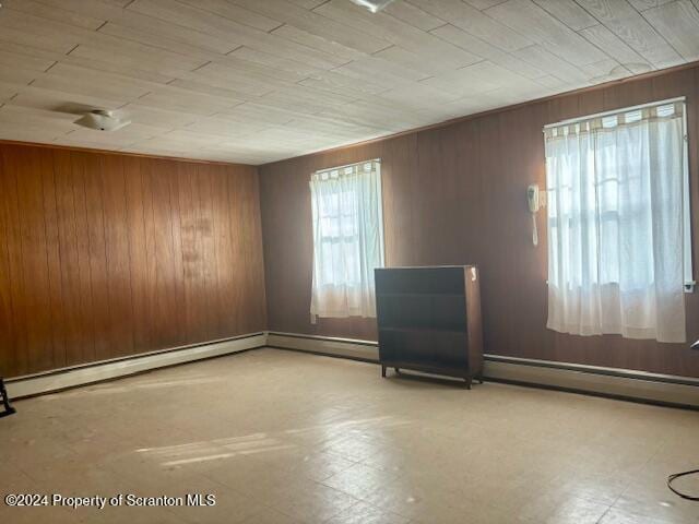 empty room with wooden walls and tile patterned floors