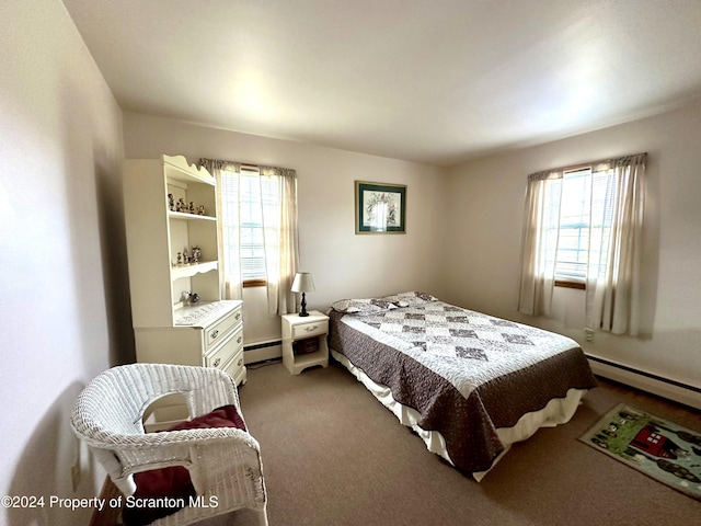 carpeted bedroom featuring baseboard heating