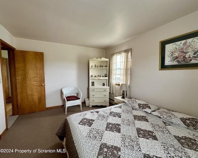 carpeted bedroom with baseboards