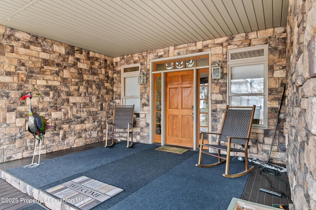 view of exterior entry featuring a porch