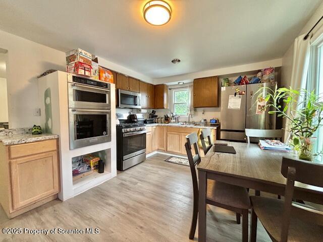 286 Meridian Ave, Scranton, PA 18504 - kitchen with appliances with stainless steel finishes, light wood-style flooring, and light brown cabinetry