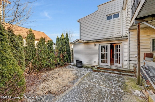 rear view of house with french doors and a patio area