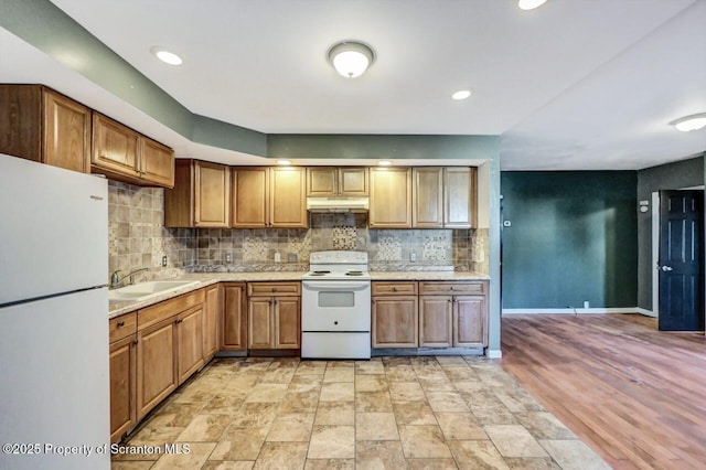 kitchen with sink, white appliances, and decorative backsplash