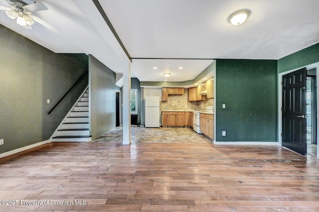 kitchen with dishwasher, backsplash, white refrigerator, ceiling fan, and light wood-type flooring