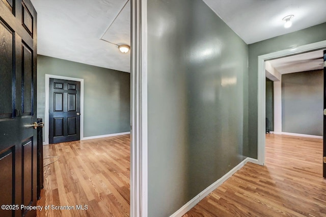 hallway with light hardwood / wood-style flooring