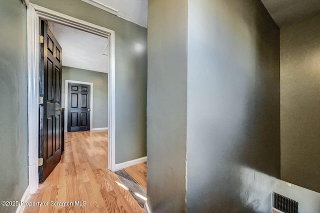 hallway with light hardwood / wood-style flooring