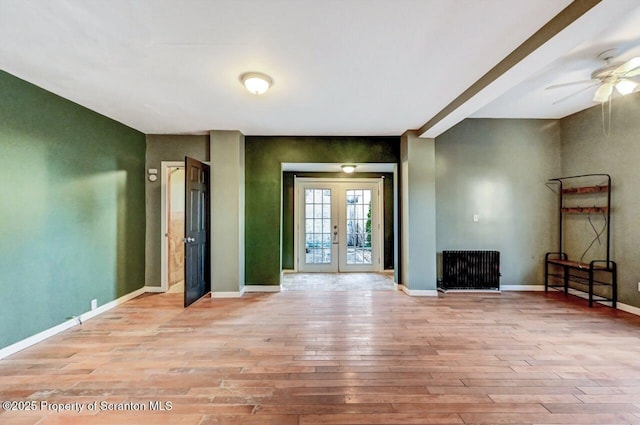 interior space with ceiling fan, light wood-type flooring, and french doors