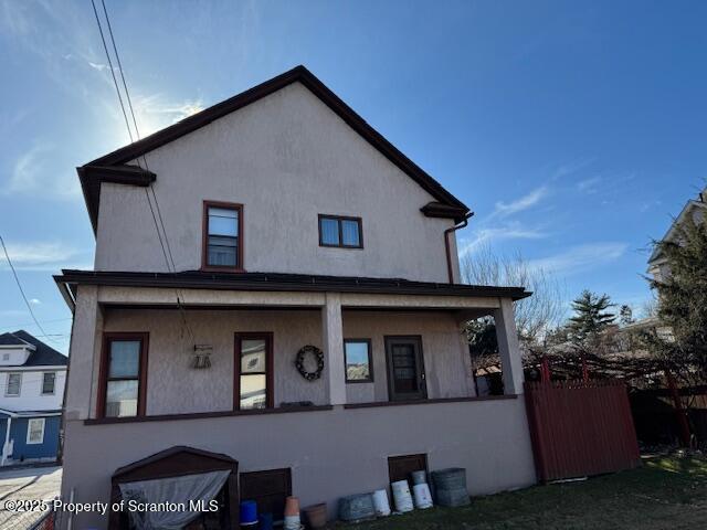 rear view of property with covered porch