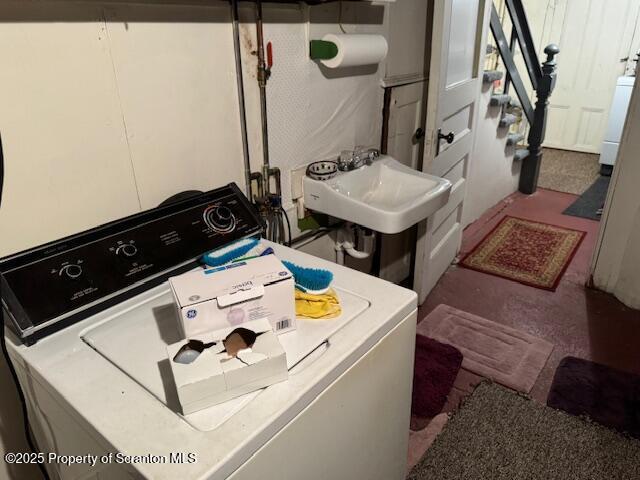 washroom with independent washer and dryer and sink