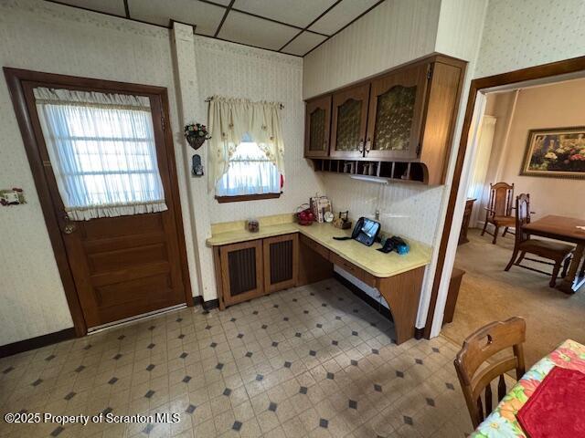 kitchen featuring a drop ceiling and plenty of natural light