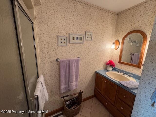 bathroom with tile patterned flooring, vanity, and walk in shower