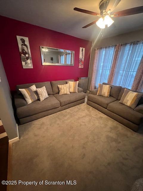 living room featuring carpet floors and ceiling fan