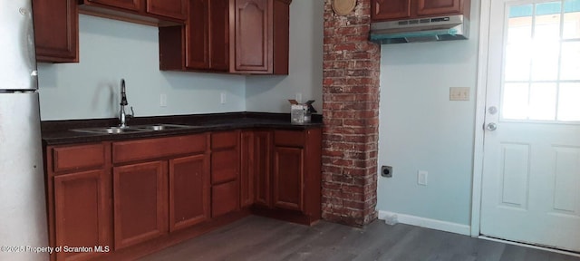 kitchen featuring stainless steel refrigerator, sink, and dark hardwood / wood-style flooring