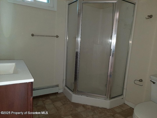 bathroom featuring toilet, vanity, baseboard heating, and a shower with shower door