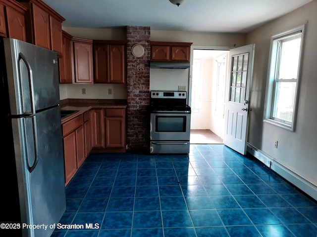 kitchen featuring appliances with stainless steel finishes, dark tile patterned flooring, and baseboard heating